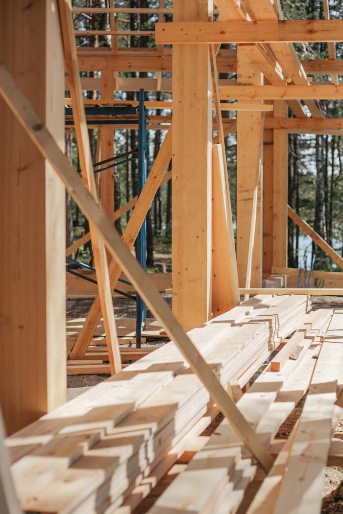 Services-01 Sunlit construction site with wooden lumber arranged in rows. Perfect for building projects.